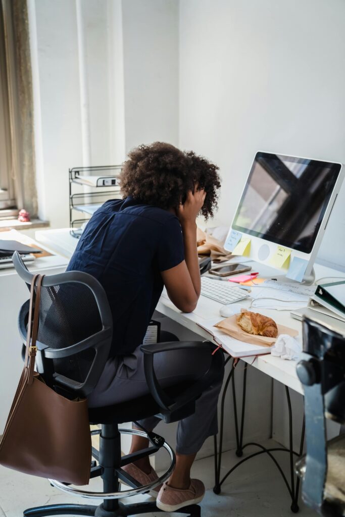 Office worker with neck pain at desk in Ottawa