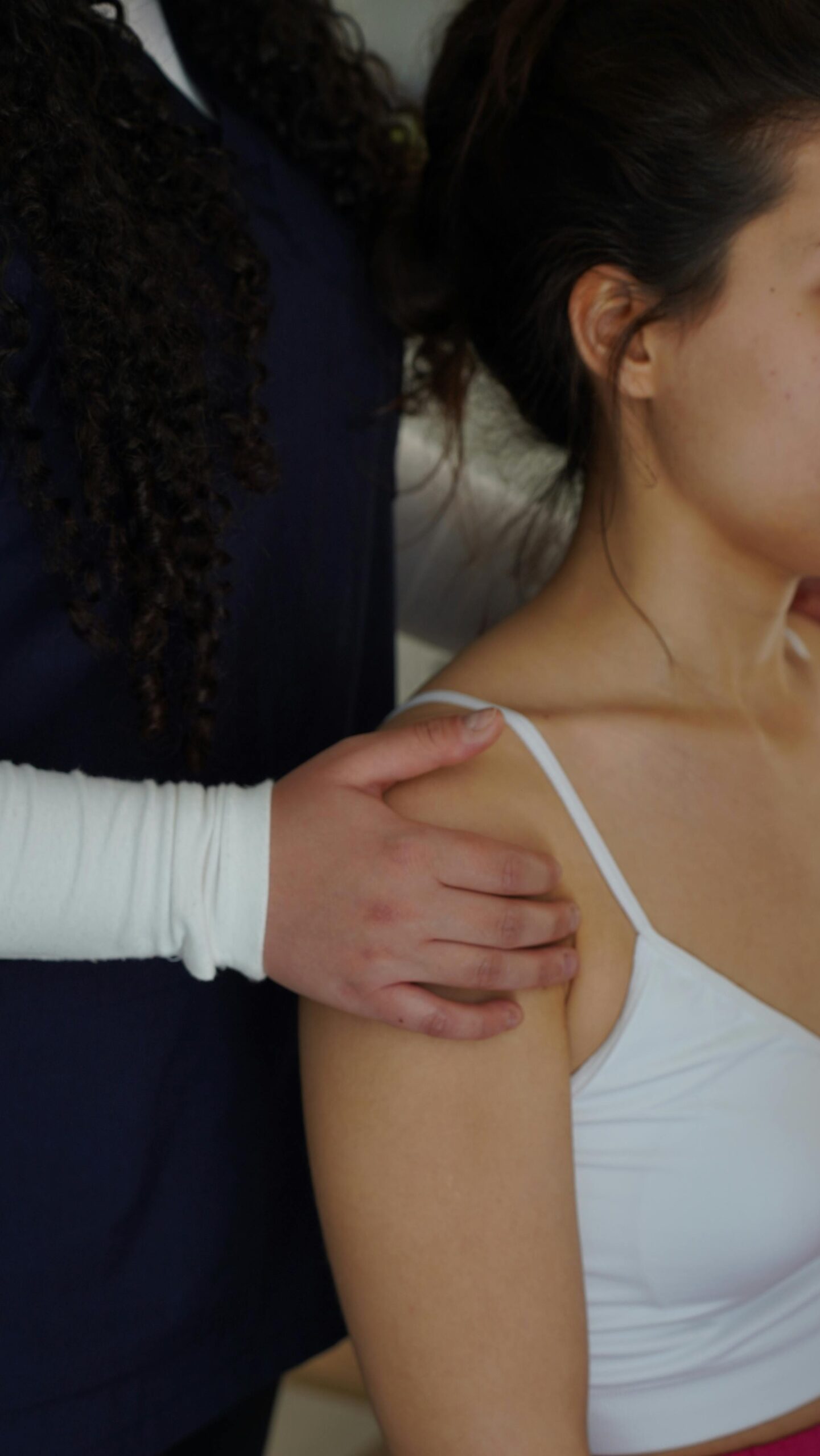 Physiotherapist assessing a patient's shoulder during a session in Ottawa