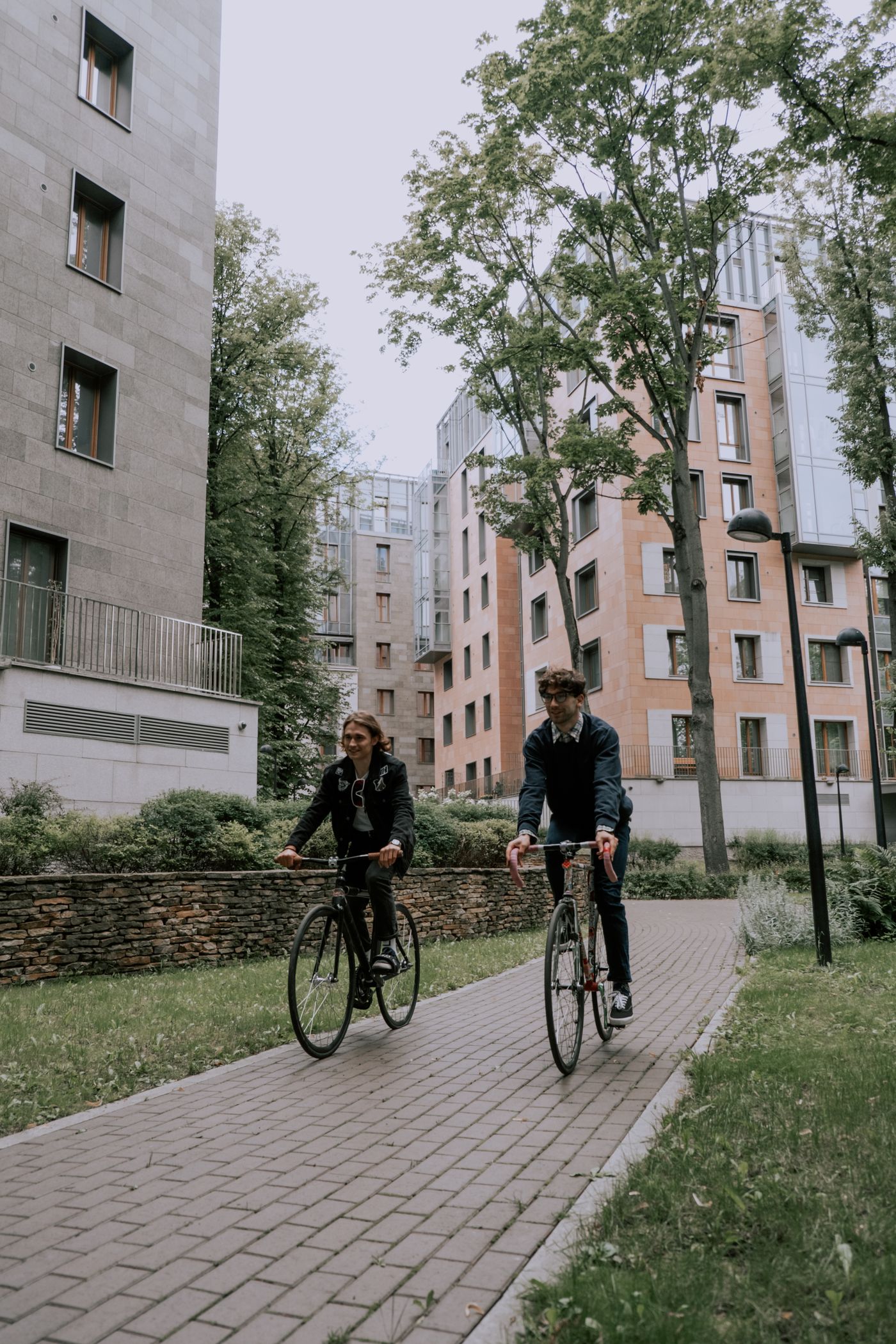 Two cyclists riding along a city path