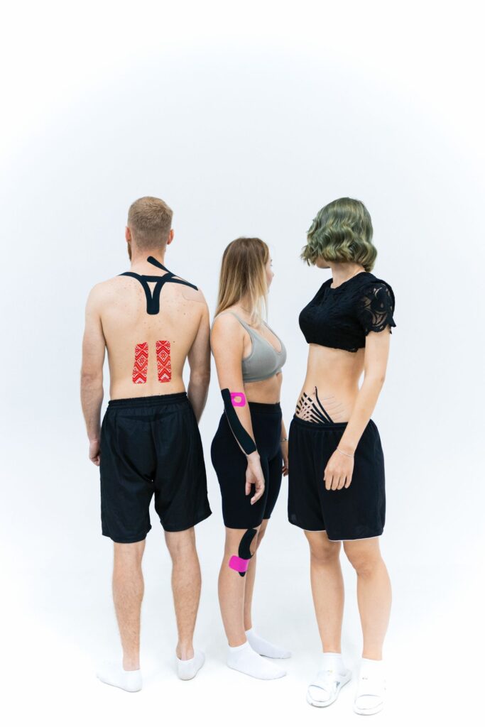 Patients with kinesiology tape applied to the lower back and knee