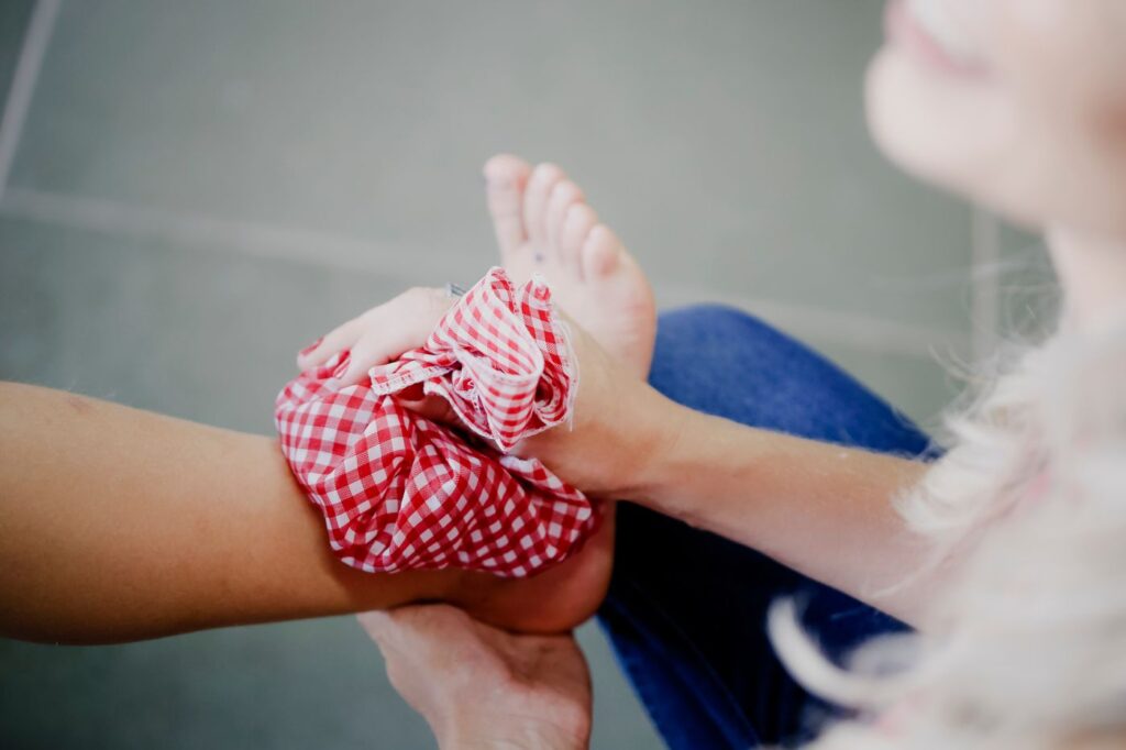 Cold compress applied to a swollen ankle after injury