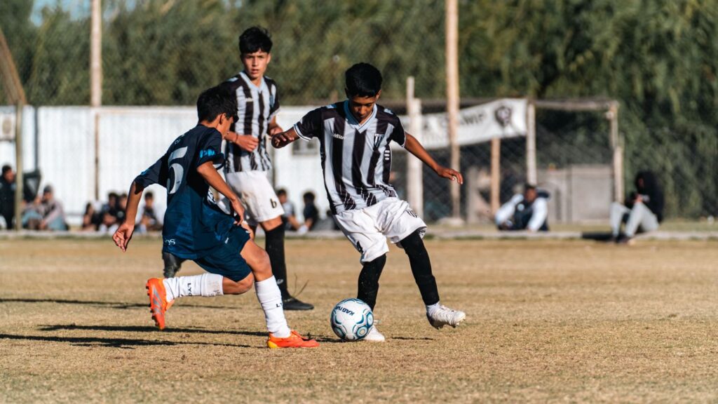 Teenagers competing in a youth soccer match